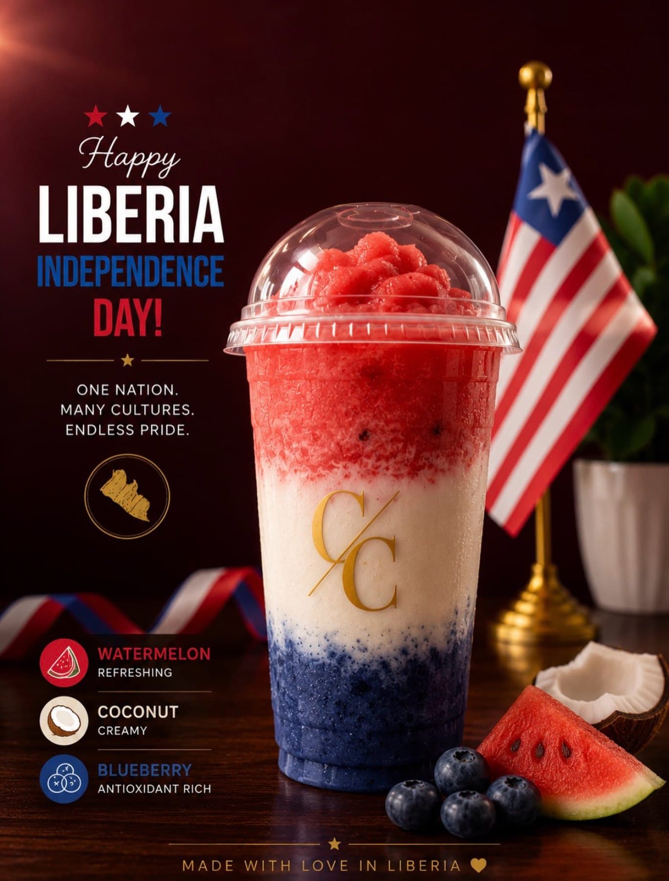 A layered watermelon, coconut and blueberry drink in Liberian flag colours beside a Liberian flag