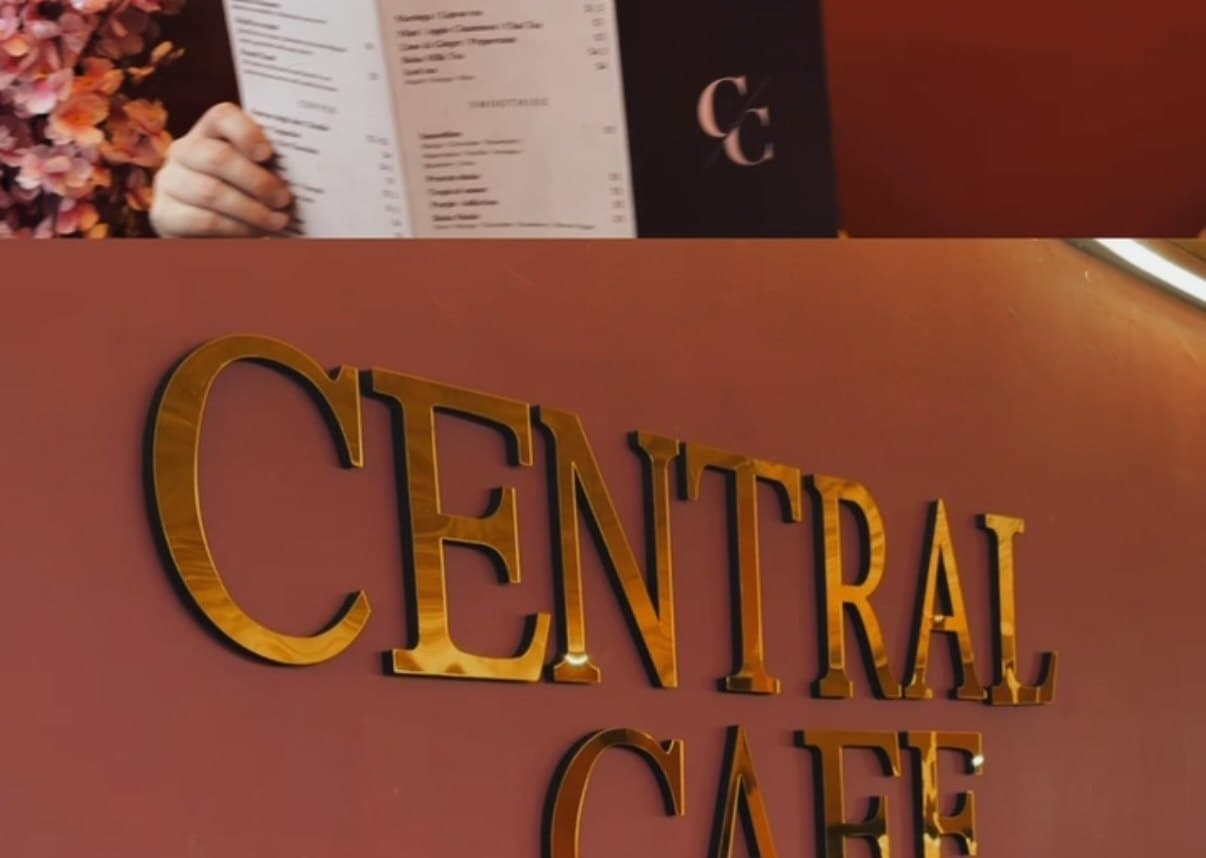 The gold Central Cafe lettering mounted on the wall of the shop