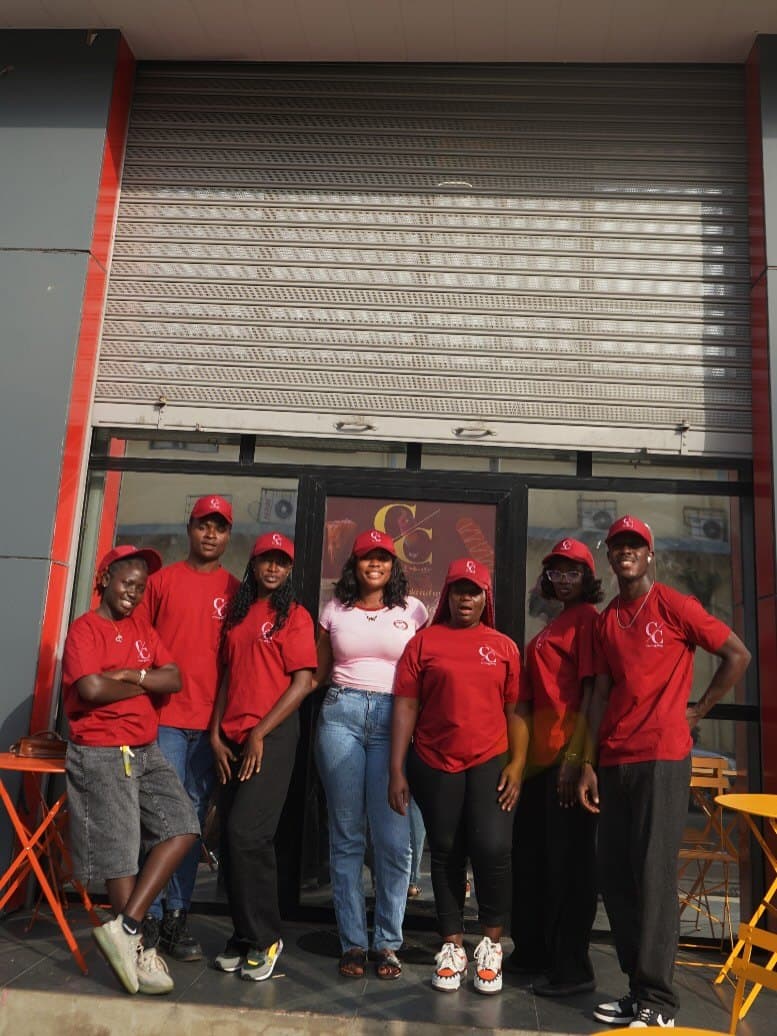 The Central Cafè team in burgundy shirts and caps outside the shop